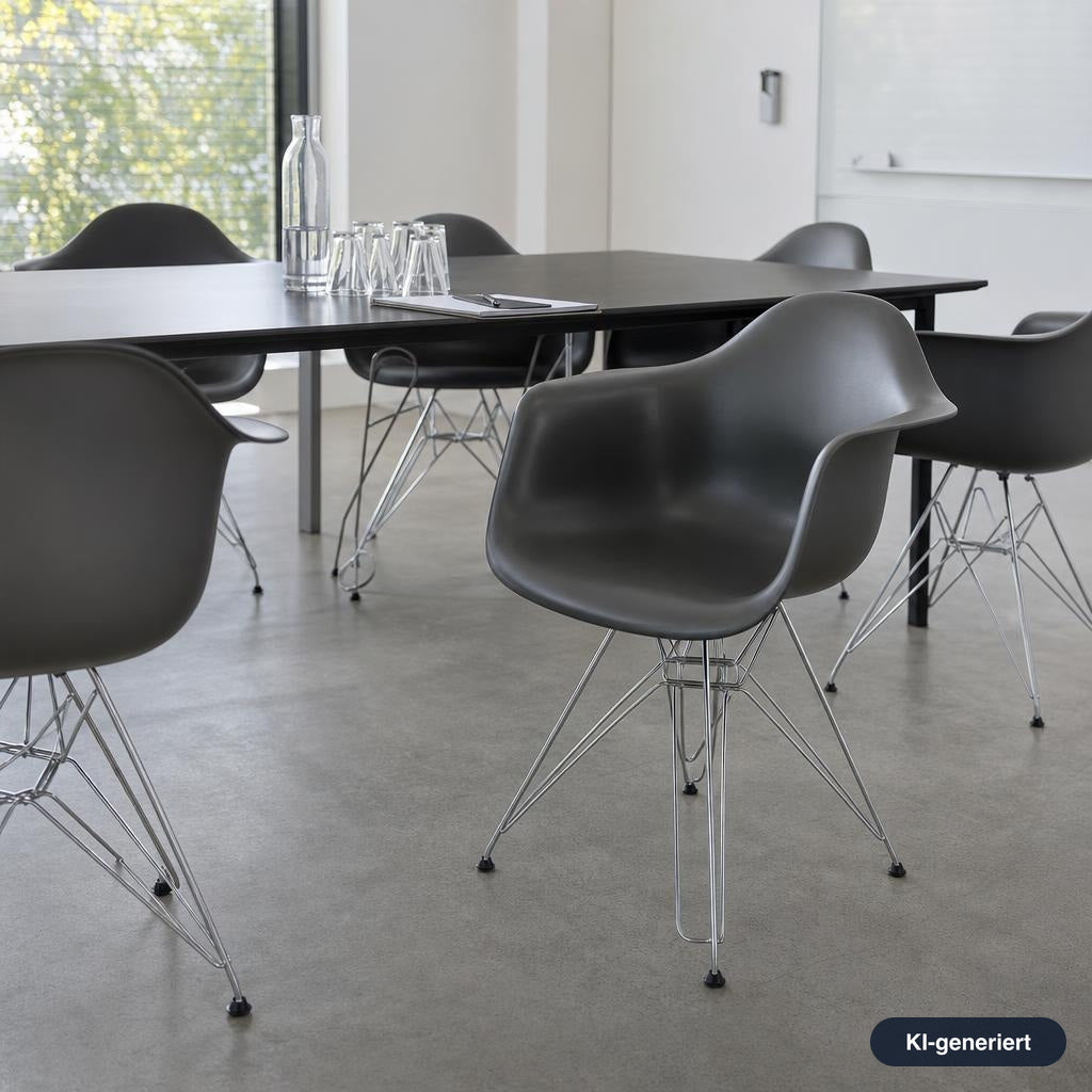 Grauer Vitra Eames Plastic Armchair DAR mit organischer Sitzschale und filigranem, verchromtem Drahtuntergestell im Büro.